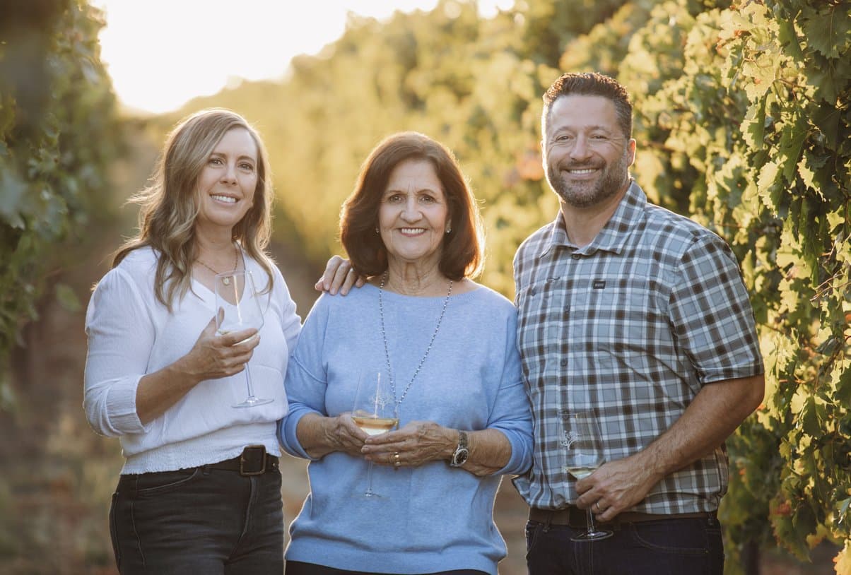 The Oak Farm Vineyards family in the vineyard at sunset
