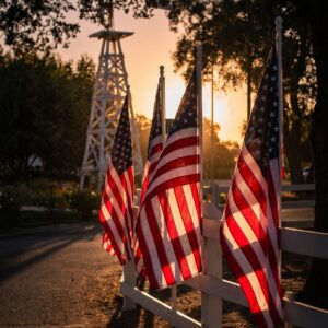 American flags along the fence at Oak Farm Vineyards at sunset
